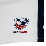 The USA Rugby 23/24 Pro Away Short by Castore is white with a stylized red, white, and blue eagle head USA Rugby logo, "USA RUGBY" text, Castore branding, and a black stripe on the right edge.