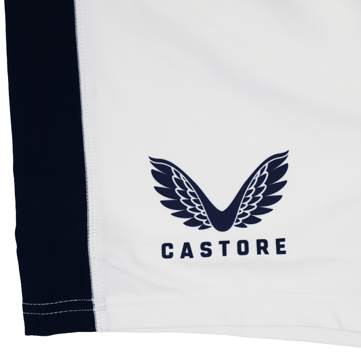 Close-up of white fabric with a black side panel and Castore logo in black. Part of the USA Rugby 23/24 Pro Away Short collection by Castore.