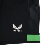 Close-up of the Harlequins 23/24 Home Shorts by Castore: black rugby shorts with a white winged Castore logo, a green band near the hem, and a geometric side pattern—part of Castore’s official collection.