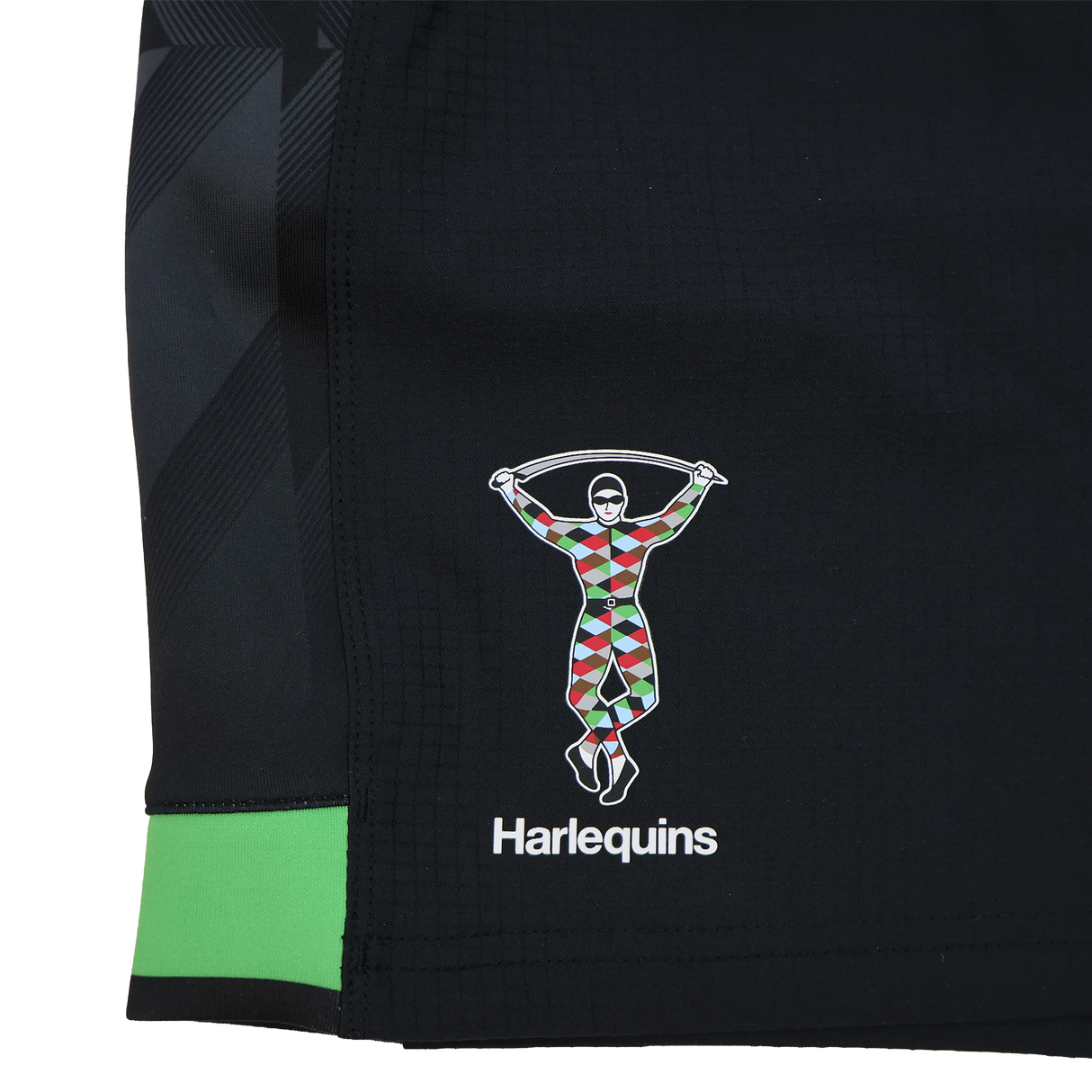 Close-up of the Harlequins 23/24 Home Shorts by Castore, featuring a black design with the club’s colorful harlequin figure and "Harlequins" printed beneath.