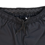 Close-up of Harlequins 23/24 Home Shorts by Castore, showcasing a black design with elastic waistband, drawstring, and zigzag stitching detail inspired by Harlequins' heritage.