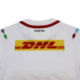Back view of the Harlequins Replica Away Jersey 23/24 by Castore in white, featuring a yellow DHL logo and "WE ARE TRUE" below the collar, plus colored shoulder accents—a stylish fan jersey from Castore.