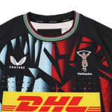 Close-up of the Harlequins 23/24 Pro 3rd Jersey by Castore, showcasing a bold geometric design, Castore and DHL logos, and the iconic team crest on the chest.