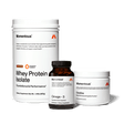 Three containers of The Momentous Three by Momentous—Whey Protein Isolate, Omega-3 softgels, and Creatine powder—are arranged on a plain white background.