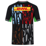 Back view of the Harlequins 23/24 Replica Third Jersey by Castore, a moisture-wicking jersey with geometric black, brown, blue, red, and gray patterns and a bold yellow DHL logo across the upper back.