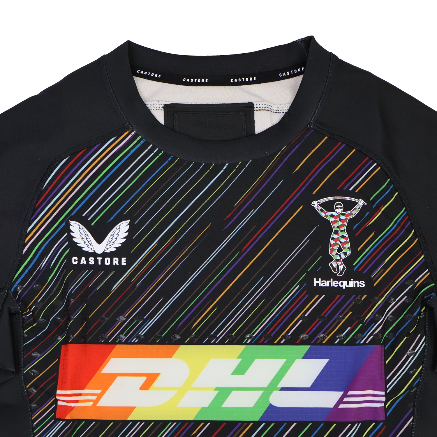 Close-up of the Harlequins 23/24 Pro Pride Jersey by Castore, a rugby jersey with vibrant rainbow stripes inspired by the Pride flag, plus DHL branding and the Harlequins emblem on the chest.