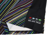 A close-up of the Harlequins 23/24 Pro Pride Jersey by Castore shows multicolored stripes, "WE ARE TRUE," and a four-color diamond design printed on a black section.
