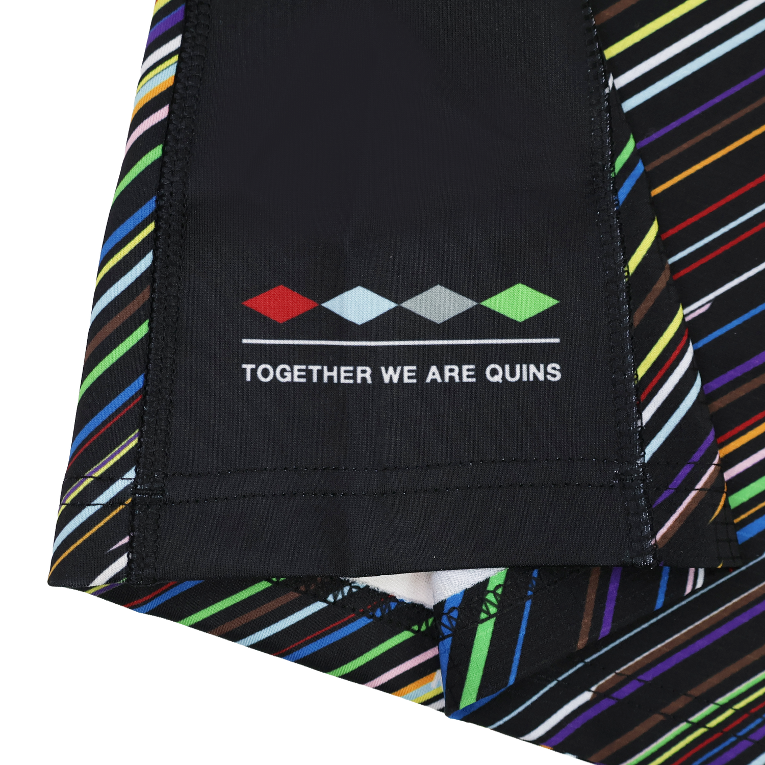 Close-up of the Harlequins 23/24 Pro Pride Jersey by Castore fabric with diagonal multicolored stripes, featuring a four-diamond logo and "TOGETHER WE ARE QUINS" text.