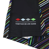 Close-up of the Harlequins 23/24 Pro Pride Jersey by Castore fabric with diagonal multicolored stripes, featuring a four-diamond logo and "TOGETHER WE ARE QUINS" text.