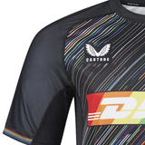 A close-up of the Harlequins Replica Pride Jersey 23/24 by Castore, a black sports shirt with multicolored stripes, featuring the Castore and DHL logos on the front.