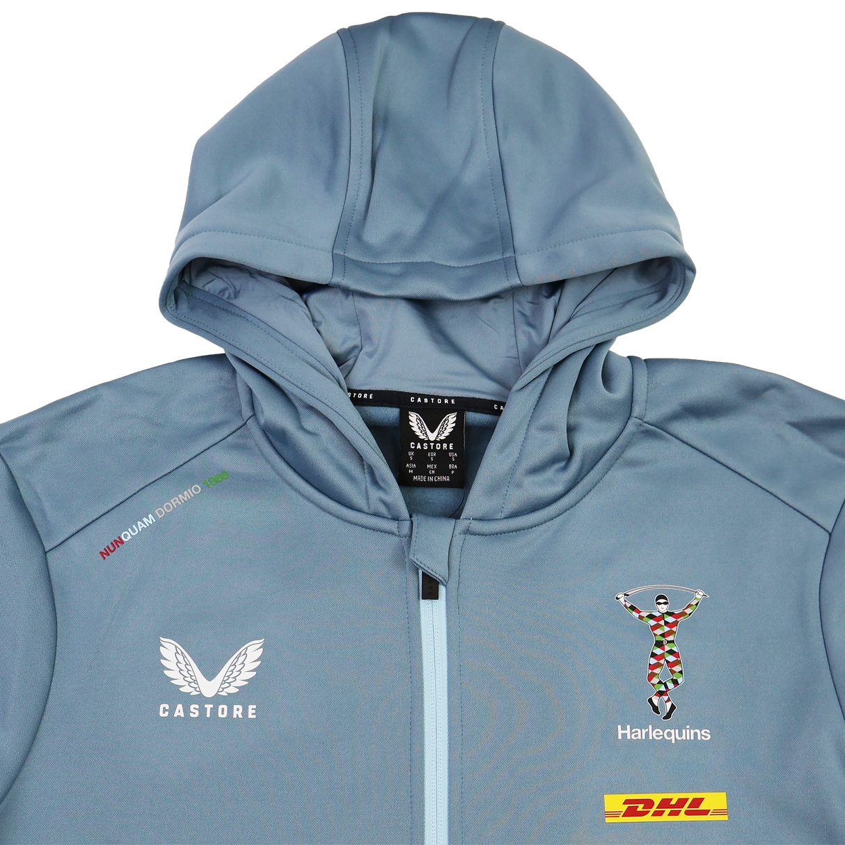 The Harlequins 23/24 Matchday Zip Through Hoodie by Castore features a light blue design, hood, DHL sponsor patch, and the iconic crest—official teamwear for Harlequins fans.