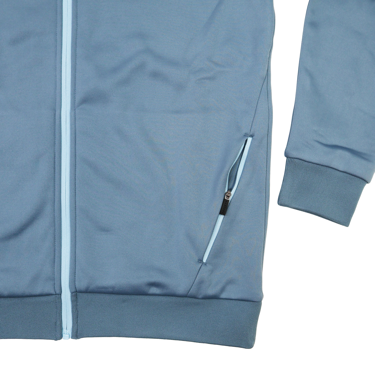 A close-up of the Castore Harlequins 23/24 Matchday Zip Through Hoodie, inspired by rugby teamwear, featuring a zipper pocket plus ribbed cuffs and hem.