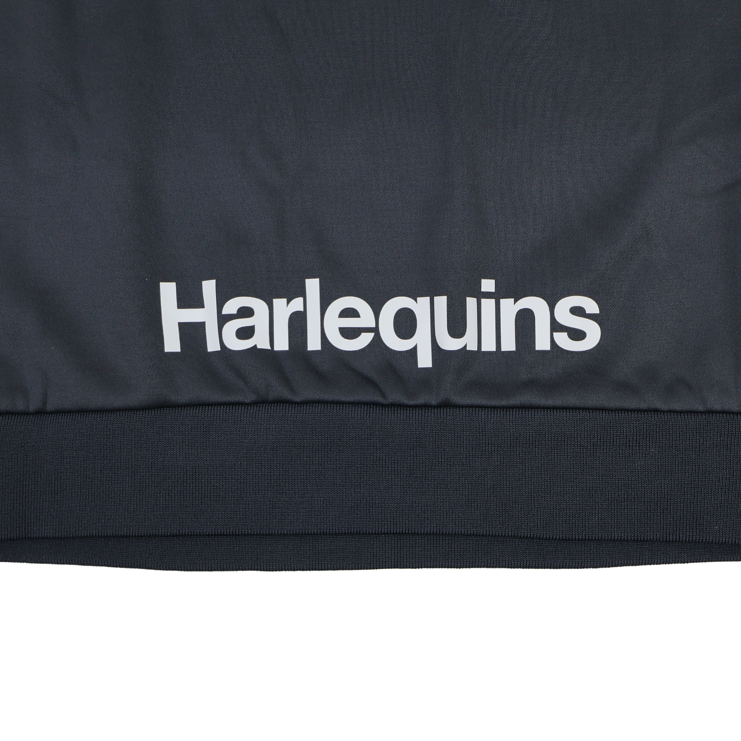 The Harlequins 23/24 Training Sweatshirt by Castore features "Harlequins" printed in white on dark fabric and is part of Castore's official training apparel.