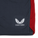 The Harlequins 23/24 Gym Short by Castore features navy blue fabric, a white stylized wings logo, a vertical red panel, and visible hem stitching—perfect for high-intensity workouts.