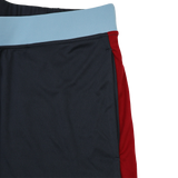 Close-up of Harlequins 23/24 Gym Short by Castore, featuring a light blue waistband, dark navy front panel, and red side panel—designed by Castore for optimal performance and style.