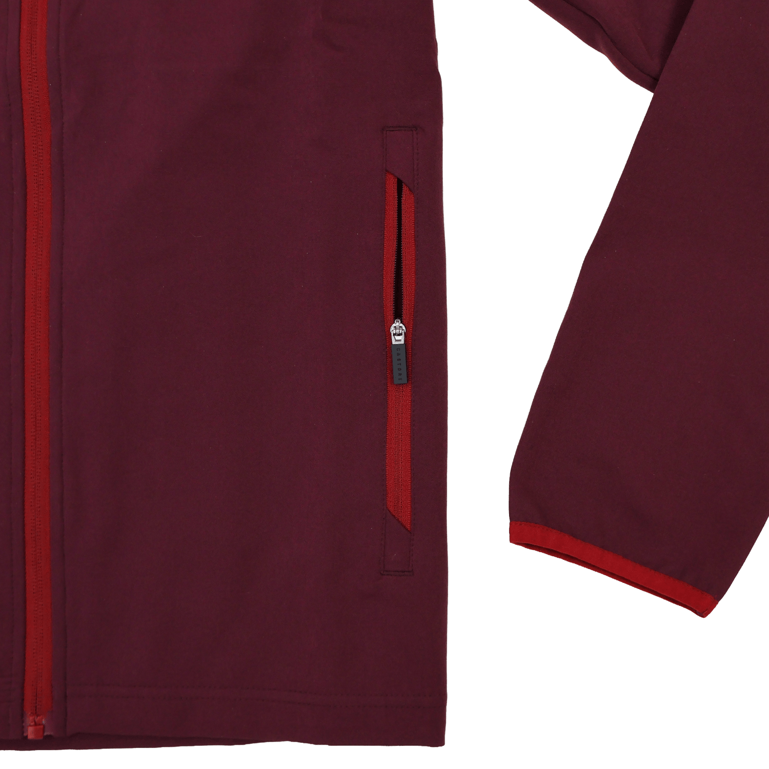 A close-up of the Scarlets 23/24 Travel Jacket Men's by Castore displays its maroon fabric and red side pocket zipper, highlighting part of the front and one sleeve against a white background.
