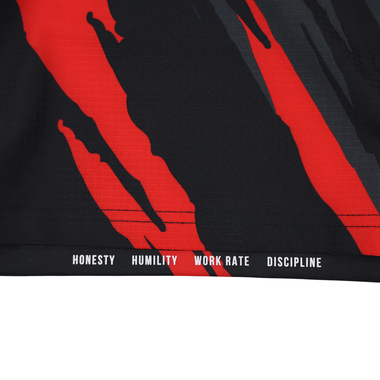 Featuring black fabric with red streaks, the Saracens Pro Home Jersey 23/24 by Castore showcases "HONESTY HUMILITY WORK RATE DISCIPLINE" in white at the hem—a bold rugby jersey for true fans.
