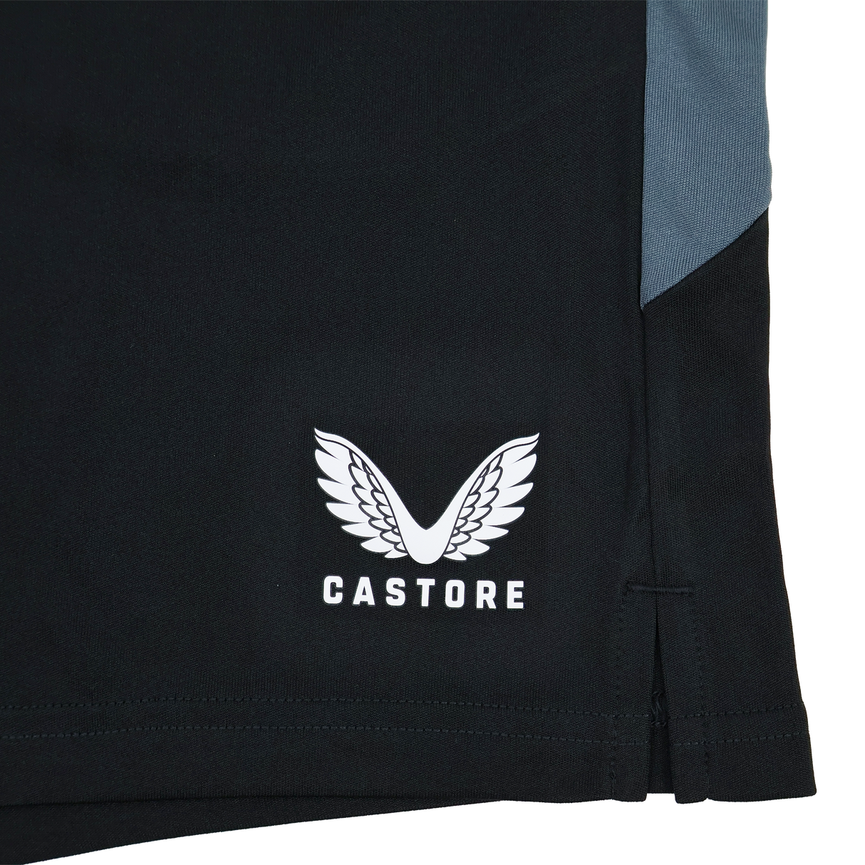 Close-up of Saracens Pro Home Shorts 23/24 by Castore, featuring black fabric, stylized wings and text logo, gray panel, and small side slit—crafted for elite performance.