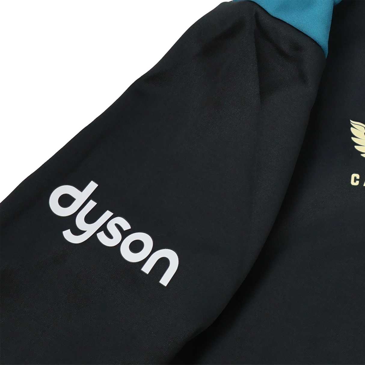 A close-up of the Bath 23/24 Full Zip Hoodie by Castore shows a black sleeve with the white "dyson" logo and a gold winged emblem—ideal fan gear from Castore for rugby supporters.