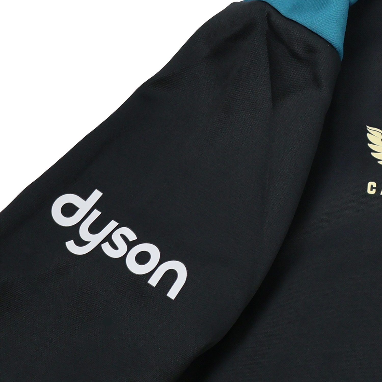 A close-up of the Bath 23/24 Full Zip Hoodie by Castore shows a black sleeve with the white "dyson" logo and a gold winged emblem—ideal fan gear from Castore for rugby supporters.