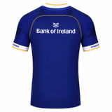 The Leinster 23/24 Replica Home Jersey by Castore is blue with white and gold trim, featuring "Bank of Ireland" logos on the back and sleeves—a must-have official jersey for true fans.
