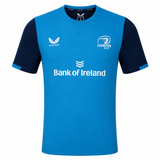 The Leinster 23/24 SS Travel Tee by Castore features blue and navy colors, short sleeves, Castore logo, Bank of Ireland sponsor, and the Leinster Rugby crest on the chest.
