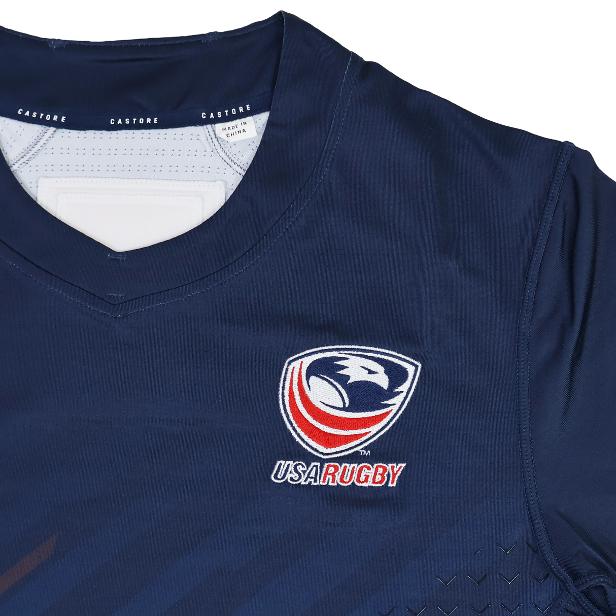 The USA Rugby 24/25 Pro Home Jersey by Castore features a navy blue design with the USA Rugby logo, eagle emblem on the chest, and signature Castore branding on the collar.