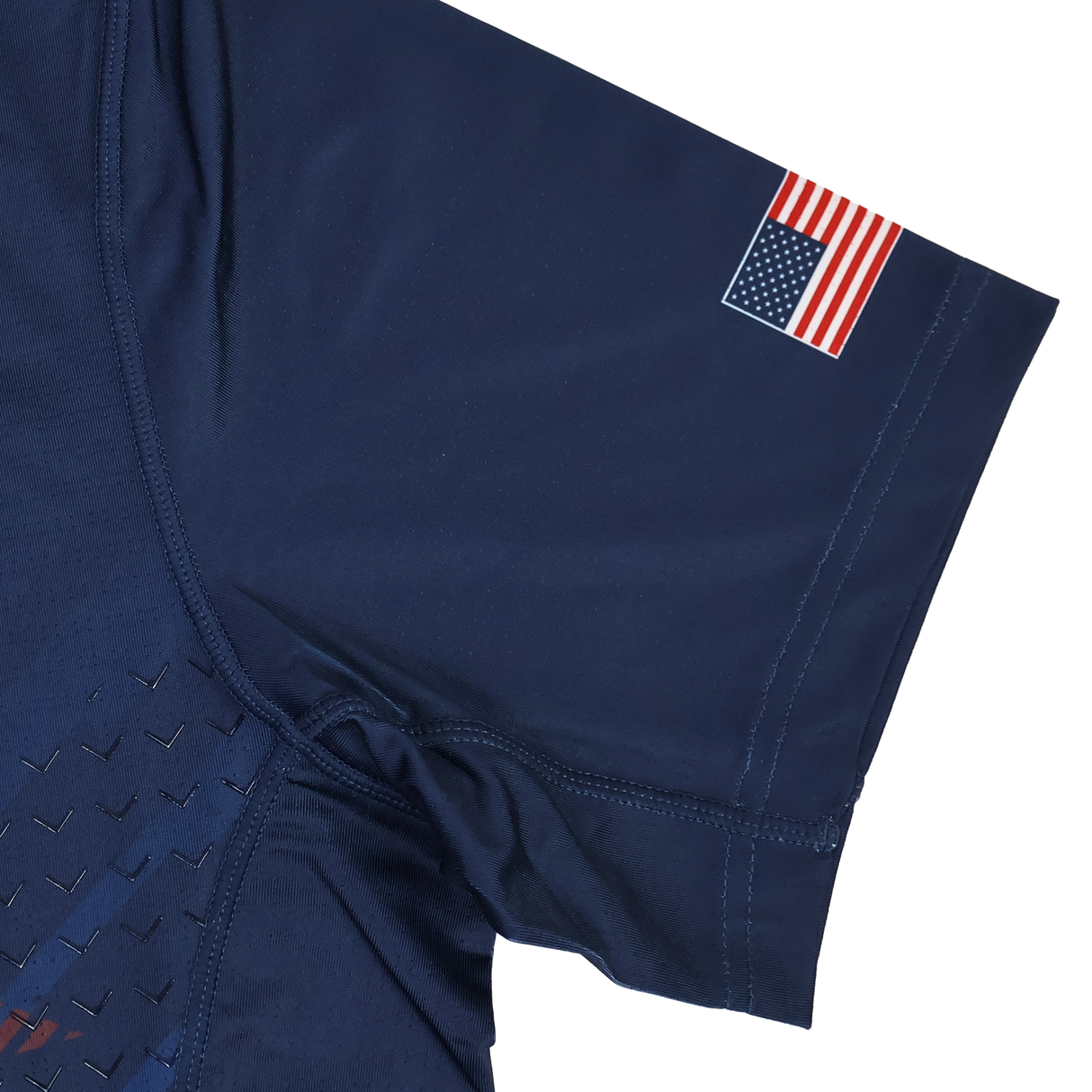 The USA Rugby 24/25 Pro Home Jersey by Castore is a navy blue short sleeve shirt inspired by the USA Rugby jersey, featuring a small American flag patch on the upper sleeve.