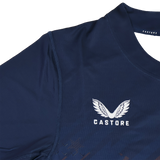 The USA Rugby 24/25 Pro Home Jersey by Castore features navy blue fabric, white embroidered Castore wings and "CASTORE" text on the chest, inspired by the official USA Rugby design.