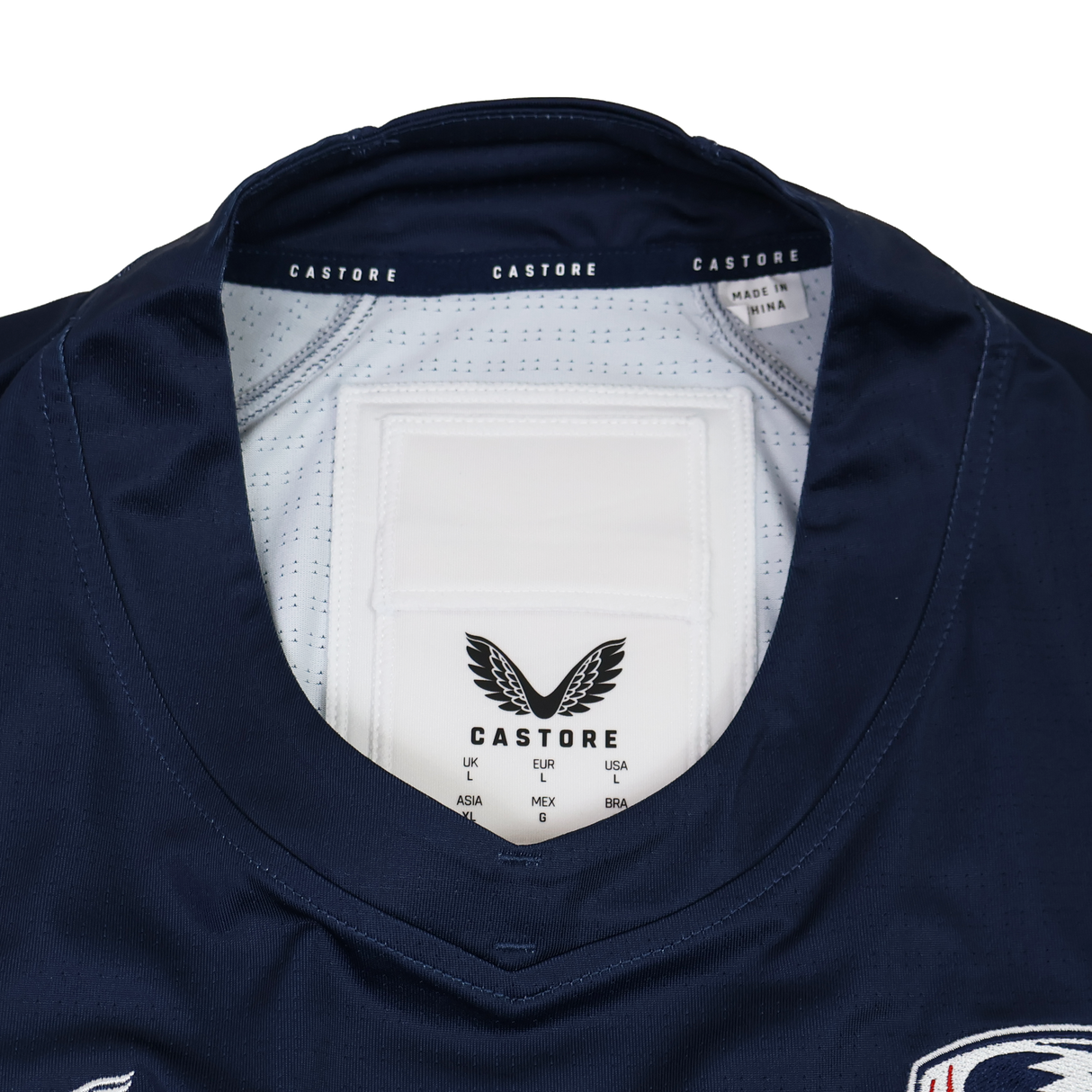 Close-up of the collar and neckline on the Castore USA Rugby 24/25 Pro Home Jersey, featuring inner tags and logo—an authentic detail from this official rugby jersey by Castore.