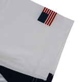 A small American flag patch is sewn onto the hem of the USA Rugby 24/25 Pro Away Jersey by Castore, featuring navy detailing and showcasing USA Rugby pride.