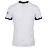 The USA Rugby 24/25 Pro 7s Away Jersey by Castore is a white short-sleeve jersey with dark collar and sleeve edges, plus an American flag patch on the right sleeve—official USA Rugby gear.