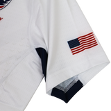 A close-up of the USA Rugby 24/25 Pro 7s Away Jersey sleeve by Castore, showing a small American flag patch near the hem.