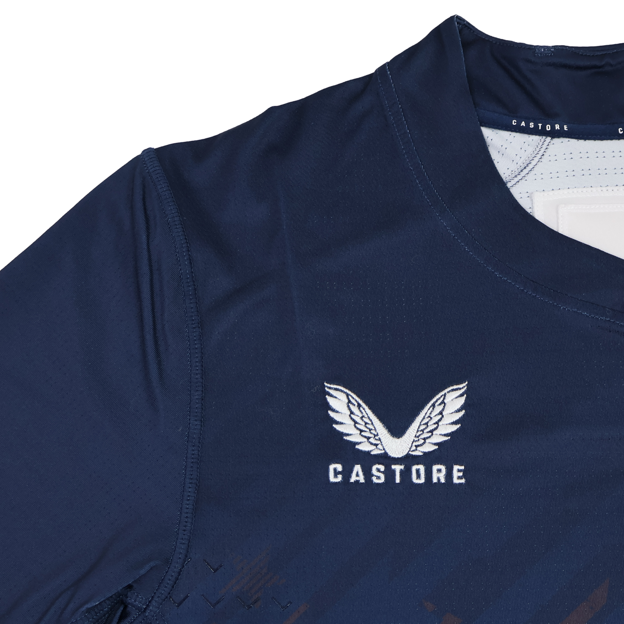 Close-up of the USA Rugby 24/25 7s Olympic Pro Home Jersey by Castore, in navy blue, featuring the Castore logo with white text and a wing design on the chest.
