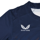 Close-up of the USA Rugby 24/25 7s Olympic Pro Home Jersey by Castore, in navy blue, featuring the Castore logo with white text and a wing design on the chest.
