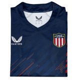 The USA Rugby 24/25 Olympic 7's Jersey by Castore features a navy blue fold, Castore logo on the left chest, USA shield on the right, and diagonal red and blue accents—ideal for Eagles fans.
