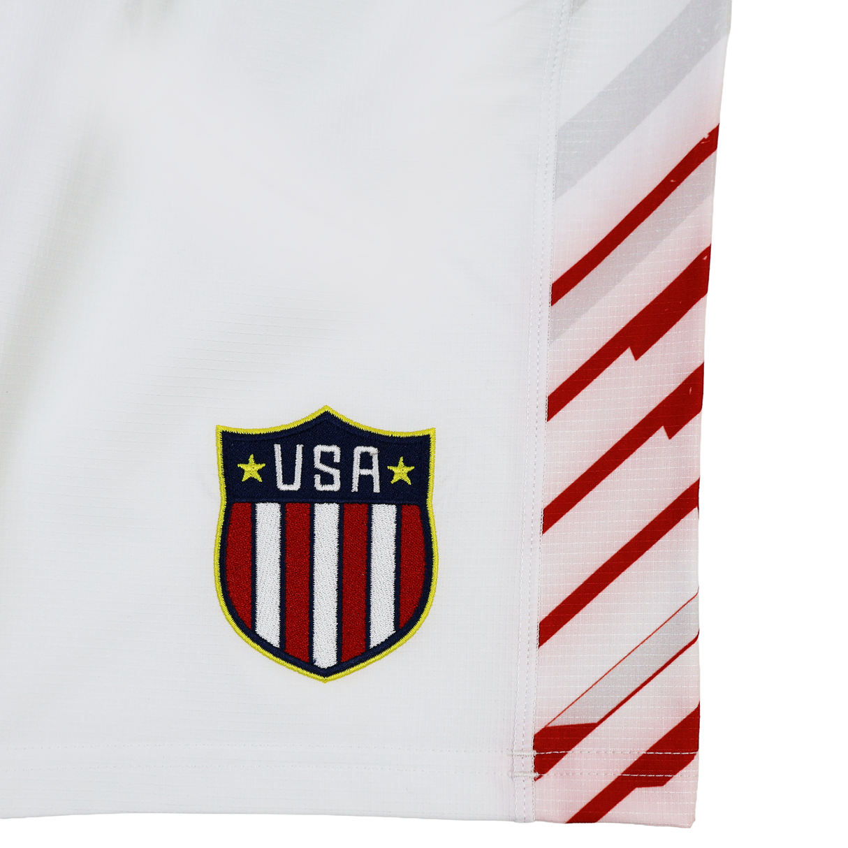 White sports jersey by Castore with USA Rugby crest and diagonal red side stripes. Pairs perfectly with the USA Rugby 24/25 7s Olympic Pro Away Short by Castore.