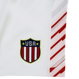 White sports jersey by Castore with USA Rugby crest and diagonal red side stripes. Pairs perfectly with the USA Rugby 24/25 7s Olympic Pro Away Short by Castore.