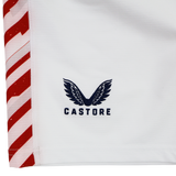 Close-up of the USA Rugby 24/25 7s Olympic Pro Away Short by Castore, showing white fabric with bold red and white diagonal edge stripes, the USA Rugby logo, and Castore’s signature black wing design.