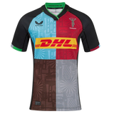 The Harlequins 24/25 Pro Home Jersey by Castore features multi-color panels with black sleeves, bold geometric patterns, a DHL chest logo, and the Harlequins crest on the left—official 2024/25 home kit.