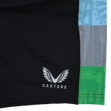 Close-up of black Harlequins 24/25 Pro Home Short by Castore with white logo and name, featuring vertical blue, gray, and green patterned stripes on the right—part of the professional rugby teamwear collection.