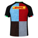 Back view of the Harlequins 24/25 Replica Home Jersey by Castore: short sleeves, black shoulders, four-color patchwork, and DHL logo on the upper back—an official rugby home jersey from Castore.