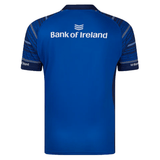 The Castore Leinster 24/25 Home Replica Jersey is blue with patterned short sleeves and features the "Bank of Ireland" logo and text on the upper back, designed for Leinster Rugby.