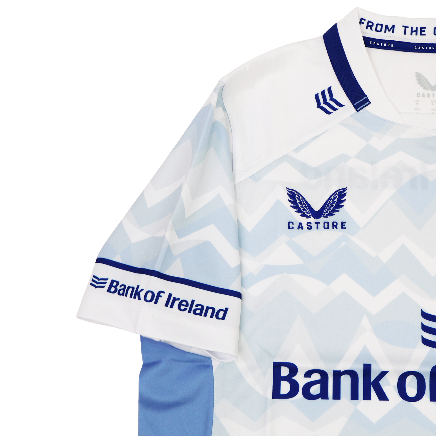 The Leinster 24/25 Replica Away Jersey by Castore features a striking light blue and white zigzag design, Bank of Ireland logos, and bold blue collar and sleeve accents—a must-have shirt for passionate Leinster Rugby fans.
