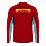 The Harlequins 24/25 Matchday 1/4 Zip Midlayer by Castore features a red body, light blue sleeves, a yellow DHL logo on the back, and small colored diamond shapes near the collar—ideal for rugby fans.