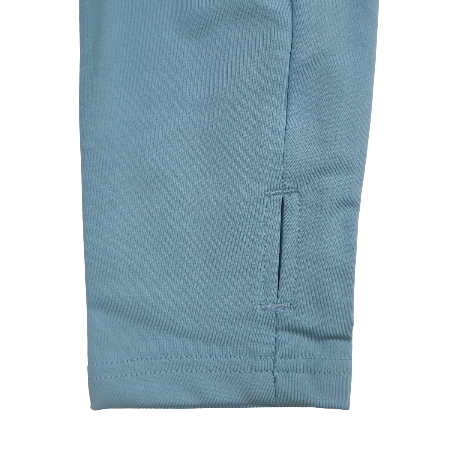 Close-up of the bottom section of a blue pant leg with a small horizontal slit near the hem and visible stitching, ideal to pair with your Castore Harlequins 24/25 Matchday 1/4 Zip Midlayer.
