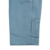 Close-up of the bottom section of a blue pant leg with a small horizontal slit near the hem and visible stitching, ideal to pair with your Castore Harlequins 24/25 Matchday 1/4 Zip Midlayer.