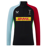 The Harlequins 24/25 Matchday 1/4 Zip Midlayer by Castore features light blue and red long sleeves, a black front, DHL sponsor logo, and both Harlequins and Castore chest logos.