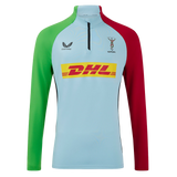 The Harlequins 24/25 Matchday 1/4 Zip Midlayer by Castore features a light blue body, green left sleeve, red right sleeve, and DHL logo—perfect for rugby fans seeking authentic style.