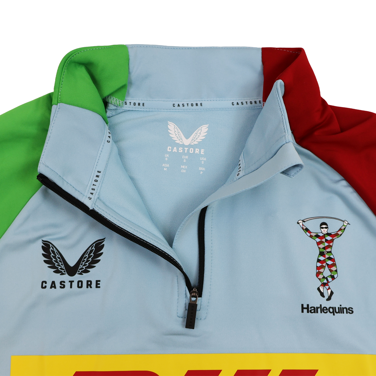Close-up of the Harlequins 24/25 Matchday 1/4 Zip Midlayer by Castore in light blue, showcasing a partial zip, Castore and DHL logos, and the iconic Harlequins team crest.